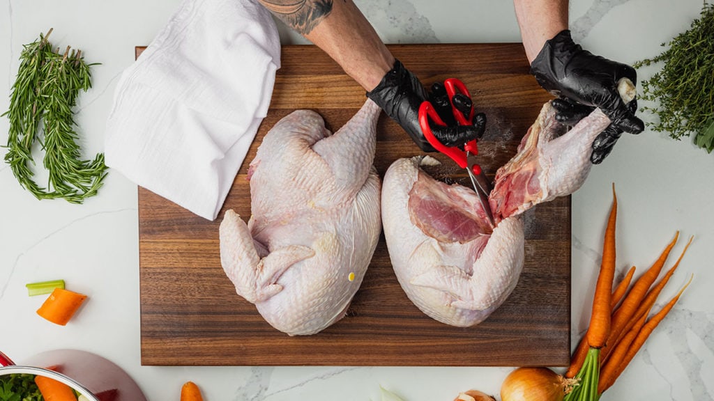 cutting off a turkey breast and leg