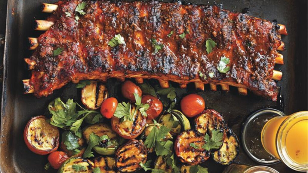 st. louis ribs with veggies in a serving plate