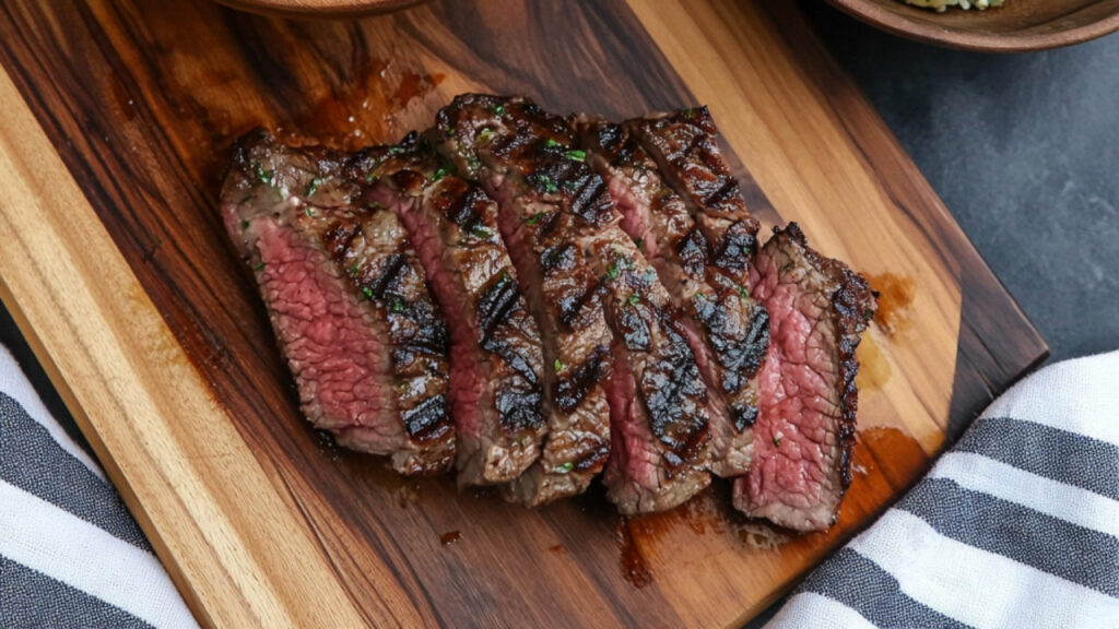 NY Strip Steak with Herby Potato Salad on a chopping board and bowl
