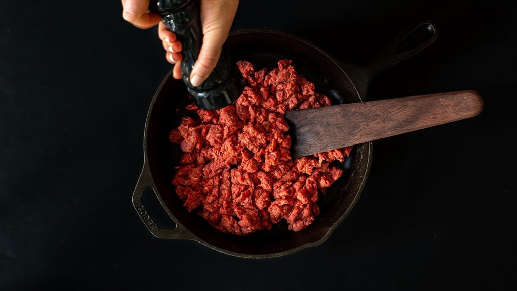 ground bison in cast iron pan